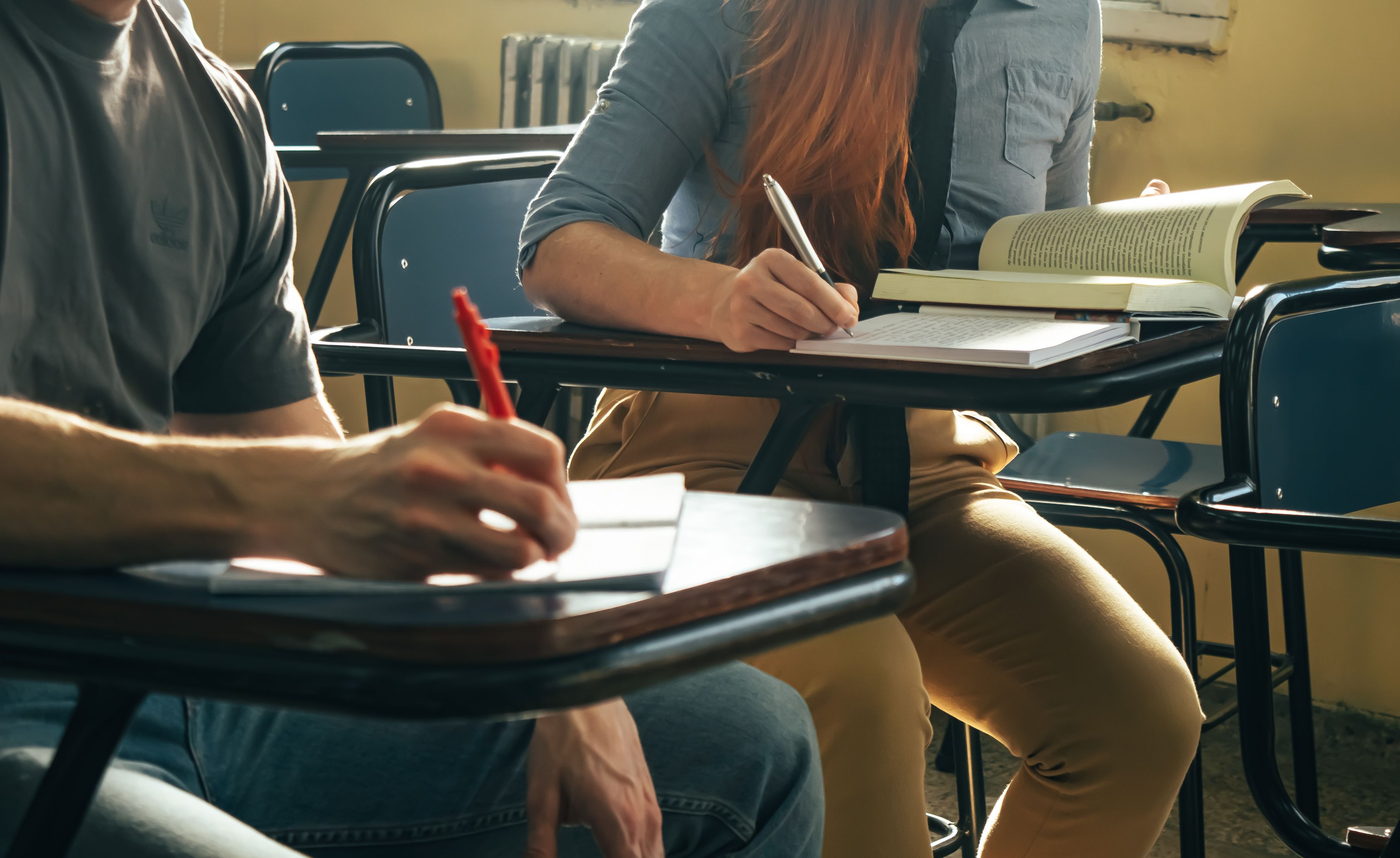 Students writing notes in class