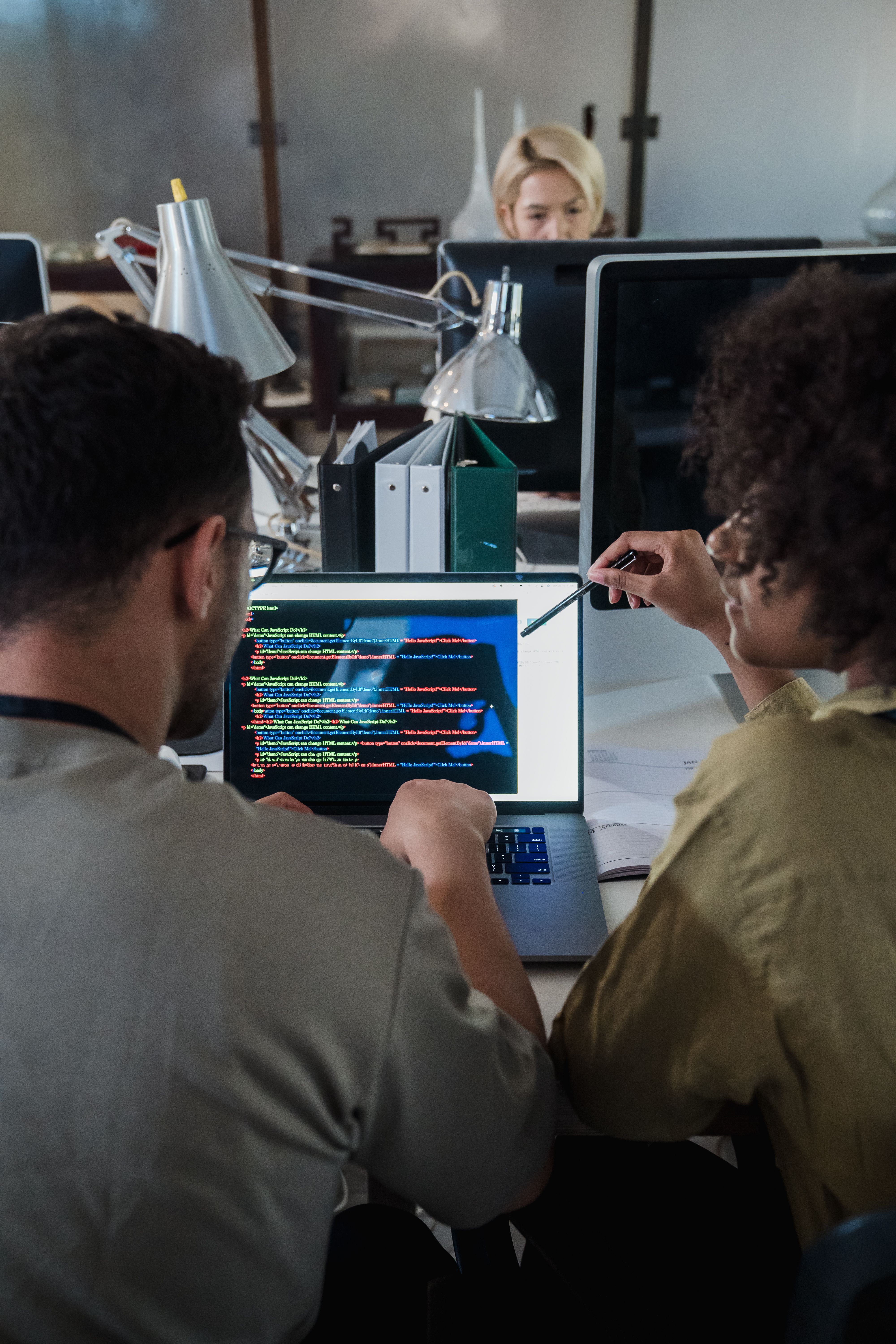 Students reviewing code during a practical class